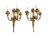 pair of antique brass wall sconces with white candles