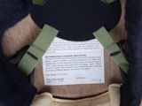 a teddy bear with a backpack on it ' s back