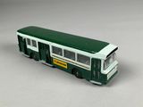 a green and white bus that is sitting on a table