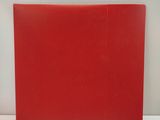 a red folder sitting on a table with a white background