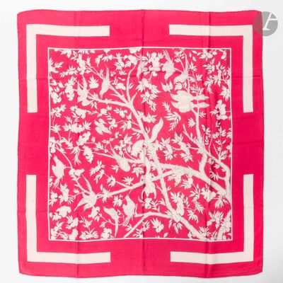 a close up of a red and white square with a bird on it