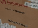 cardboard box sitting on the ground with a pair of scissors in it