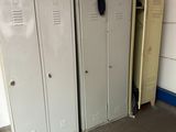 three lockers in a room with one open and the other closed