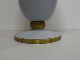 an image of a blue vase with a gold base on a white surface