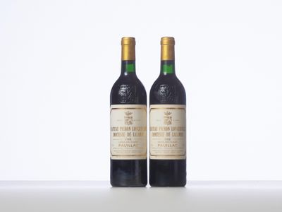 two bottles of wine sitting next to each other on a table