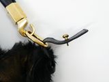 a black and gold purse hanging on a hook