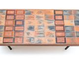 a coffee table with a tile top on a white background