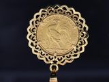 a close up of a gold coin on a black background