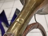 a large brass trumpet sitting on a stand in a room