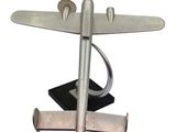 a silver model of a plane on a black base
