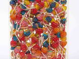 a clear box filled with lots of colorful lollipops