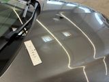 a sticker on the hood of a car that is parked in a garage