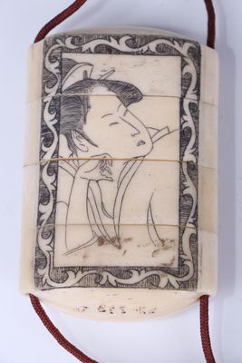 an antique chinese carved ivory box with a picture of a man