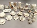 many different types of teapots and saucers on the table