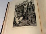 an open book with a picture of a castle on it