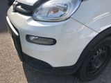 a close up of a white smart car parked in a parking lot