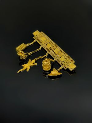 un gros plan d'un collier en or orné de breloques
