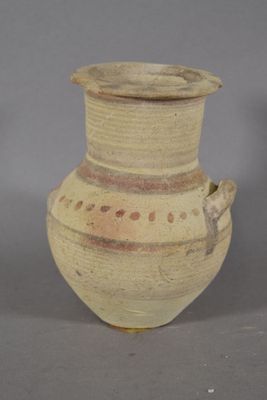 a vase that is sitting on a table with a gray background