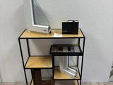a computer desk with a monitor on top of it