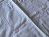 a close up of a white table cloth on a table