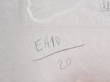 a hand holding a piece of paper that has writing on it