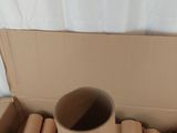 a cardboard box full of cardboard tubes sitting on the floor