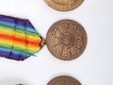 three medals and a medal on a white surface with a white background