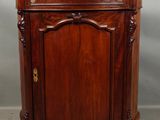 a wooden cabinet with a door and a drawer on top of it