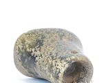 a stone object that is sitting on a white surface