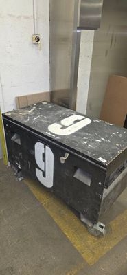une boîte noire portant un numéro, posée dans un garage
