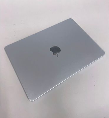 a silver apple laptop sitting on a white table