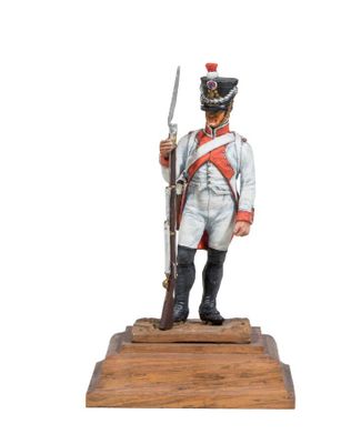 statue of a man in a uniform with a sword on a wooden base