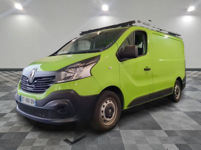 the green van is parked on a checkered tile floor