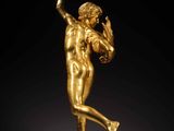a gold statue of a man holding a football ball