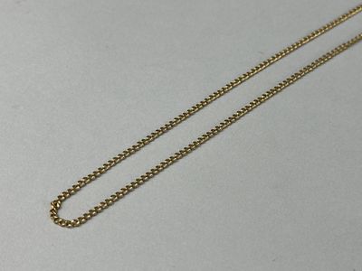 a close up of a gold chain on a white surface