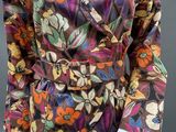 an image of a mannequin wearing a colorful floral shirt and brown skirt