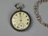 a silver pocket watch with a chain around it