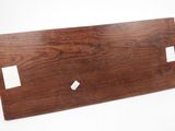 a close up of a piece of wood on a white surface