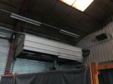 ceiling mounted air conditioner in a building with a black tarp