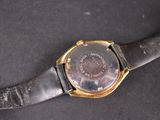 a close up of a watch on a black surface