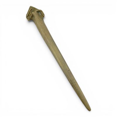 an old wooden knife on a white surface with a white background