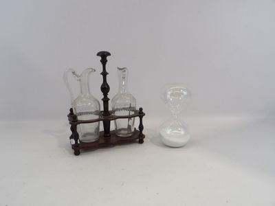three glass vases and a candle holder on a table