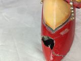 a close up of a red shoe with a bird on it