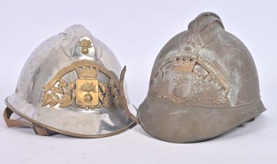 two helmets that are sitting side by side on a white surface
