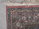 a rug on the floor with a cat laying on it