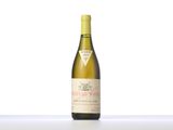 the bottle of white wine is sitting on the table