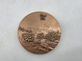 an image of a medal with a boat in the water