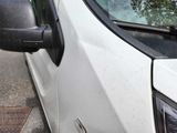 a white van that is parked on the side of the street