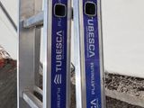 two skis sitting on top of a metal ladder