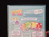 a card game set up on a table next to other cards
